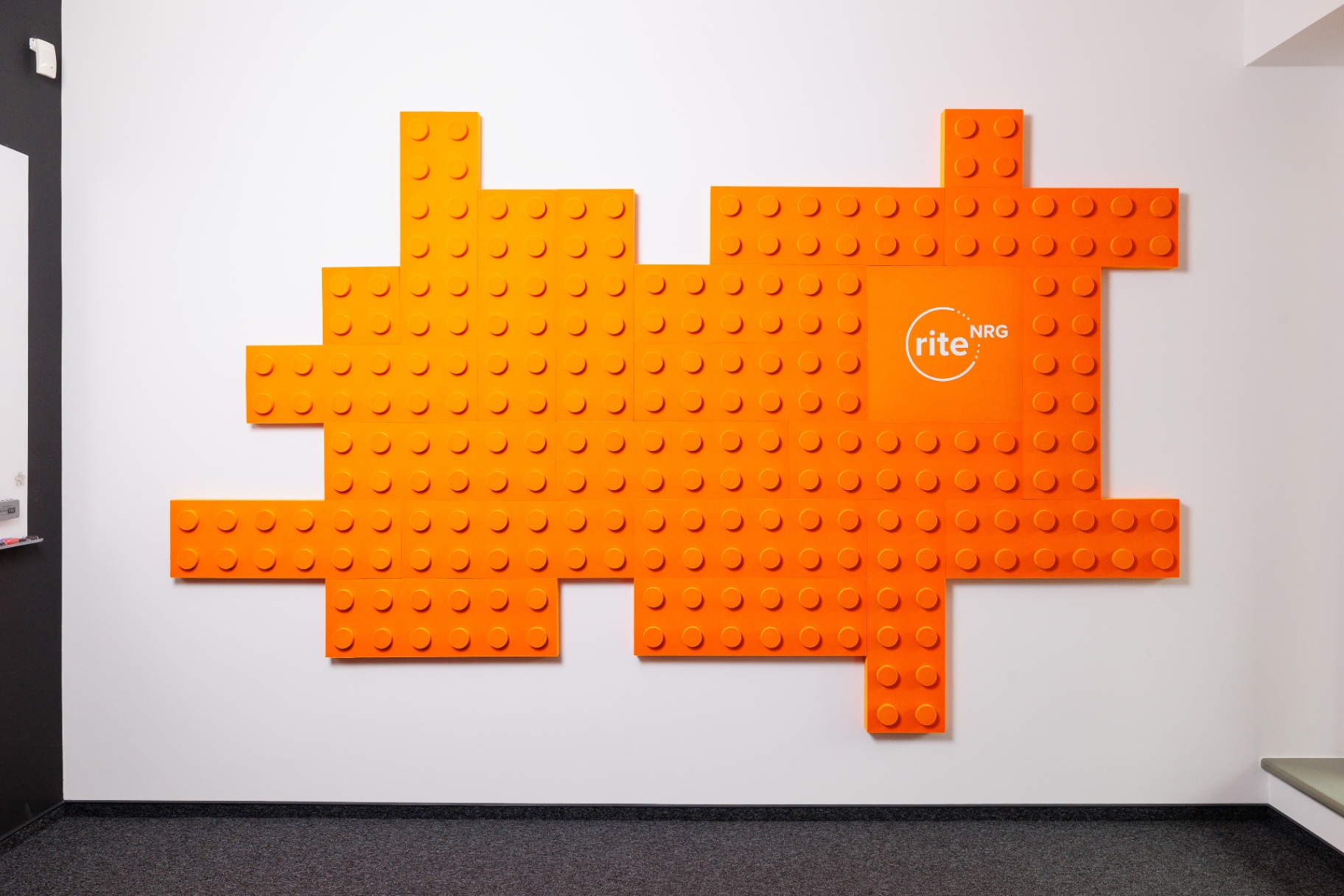 The orange brick hashtag wall in the RITE NRG office