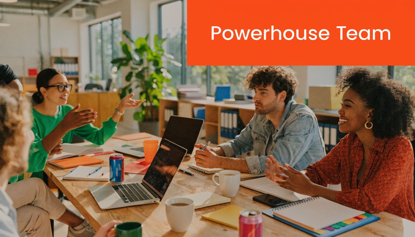 A diverse group of professionals collaborating together around a desk in a bright, modern office space.
