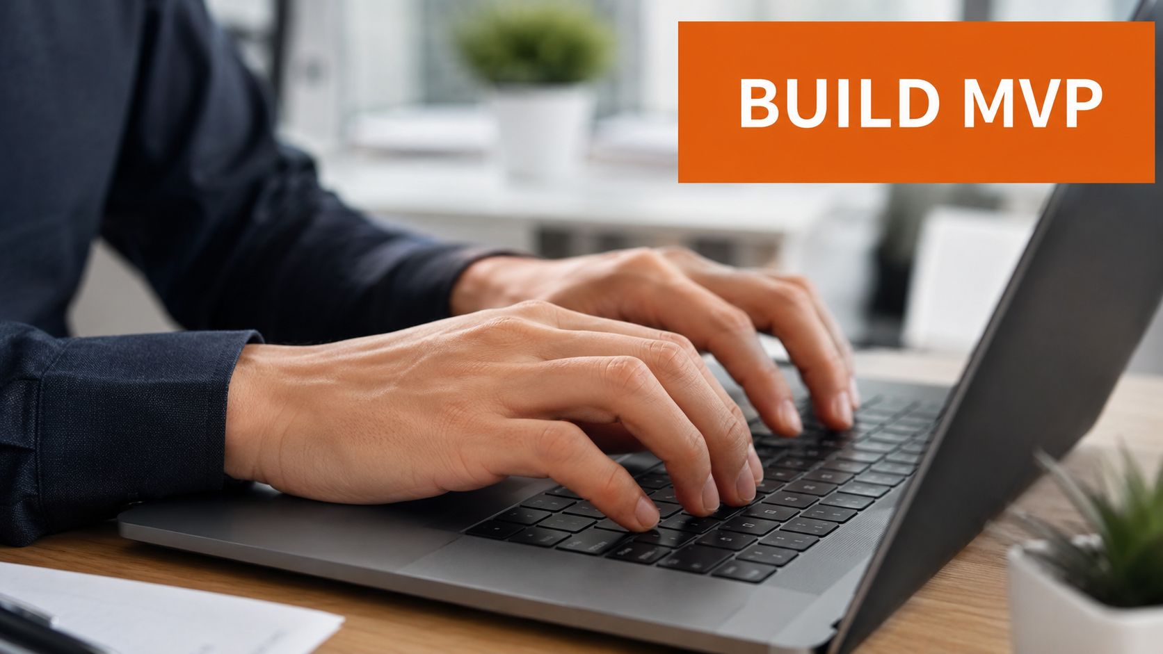 A close-up view of a person typing on a laptop with the text BUILD MVP overlayed